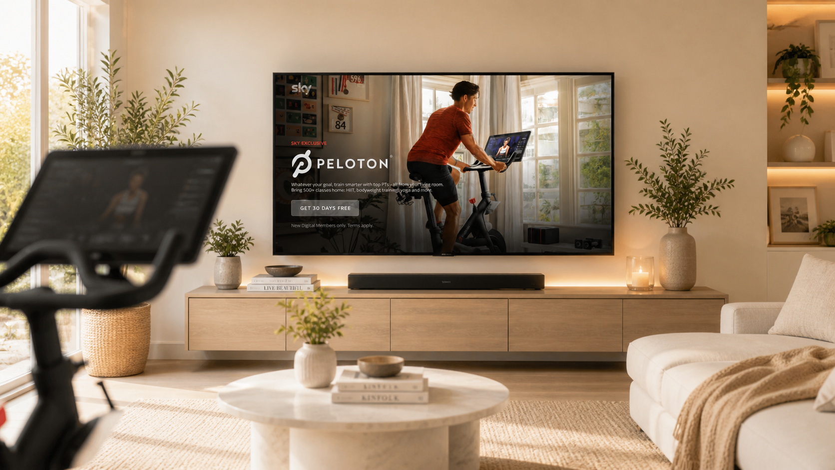 Peloton on Sky in a bright modern living room, with a Peloton bike in the foreground